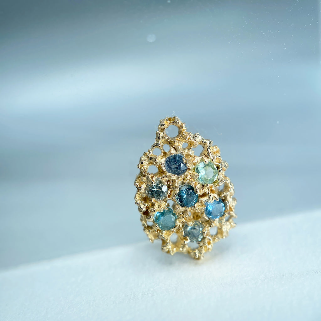 Textured, lacy, lemon-shaped pendant or earring, shown in 14k yellow with a mix of bluish-green stones