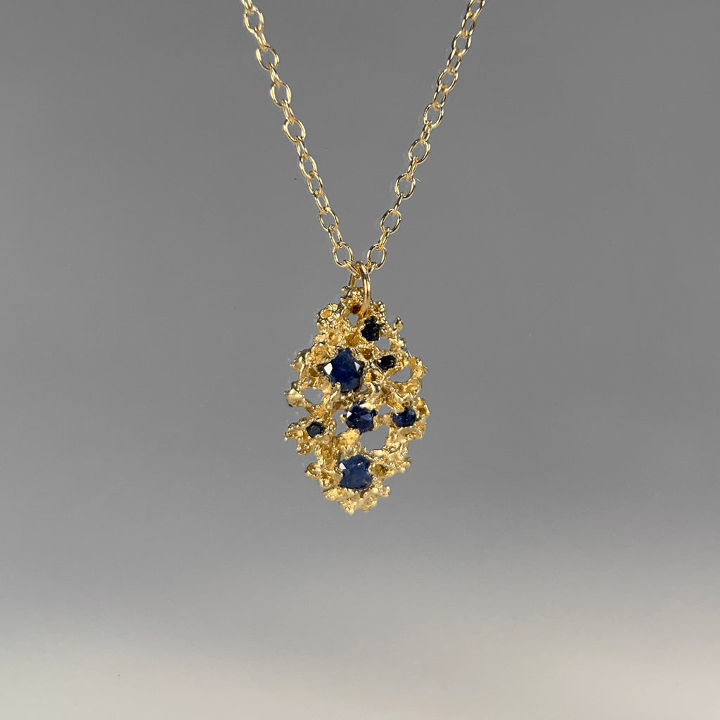 Very lightweight, lacy, leaf-shaped, textured necklace with 7 blue sapphires in various sizes