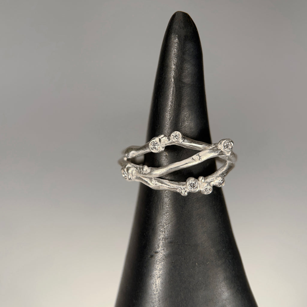 Organic, branch-like ring with three branches. Seven tiny diamond buds per ring. Shown in silver.