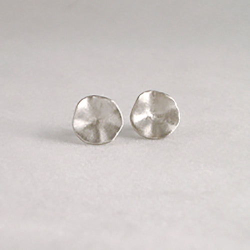 Soft, round, organic, slightly concave stud earring with hilly edges