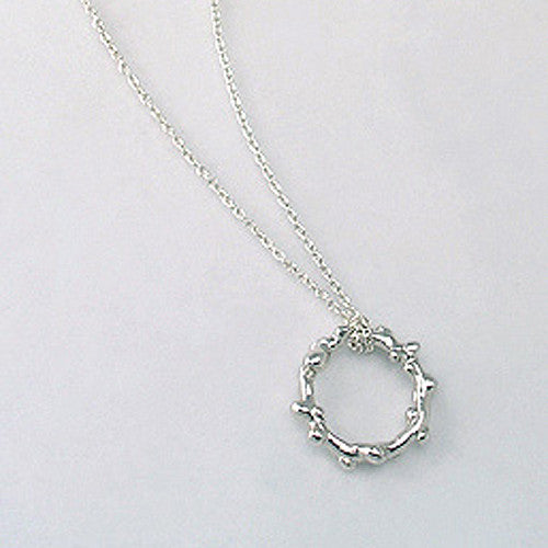 Branch-like necklace in round shape; organic and asymmetrical; shown in polished silver